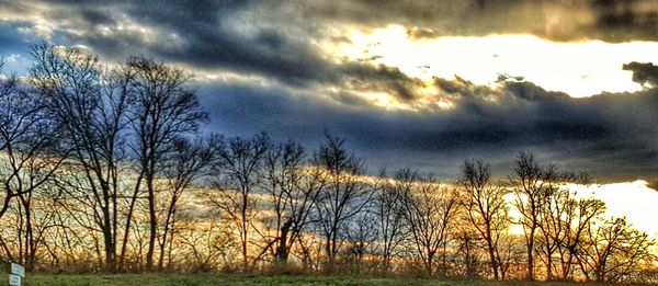 Scenic view of field against cloudy sky