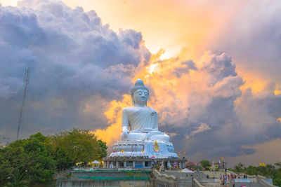 Statue of temple against building