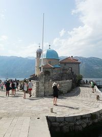 People on mountain against sky