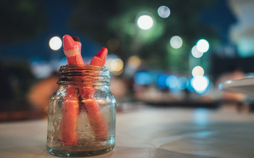 Close-up of crayons in jar on table