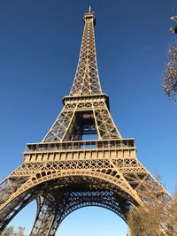 Low angle view of eiffel tower against clear blue sky