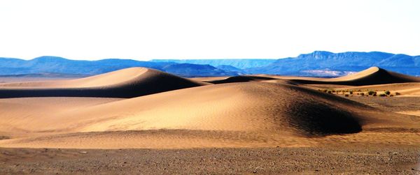 Scenic view of desert against clear sky