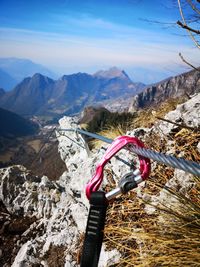 Umbrella on rock by mountains against sky