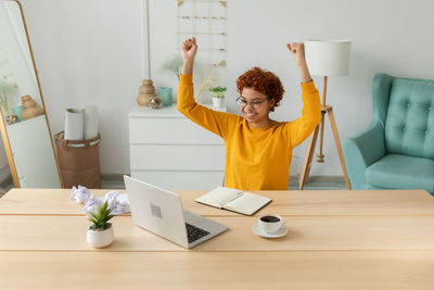 Portrait of woman using laptop at home