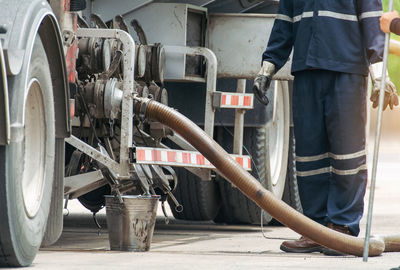 Low section of man standing by truck outdoors