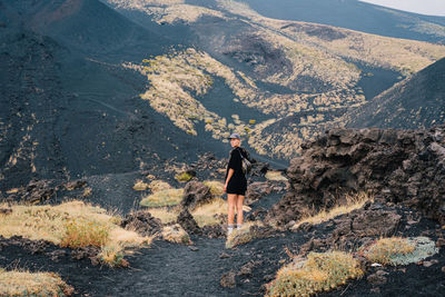 Rear view of man walking on mountain