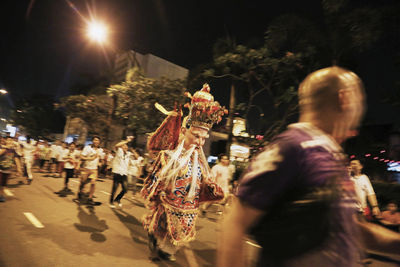 People on street in city at night