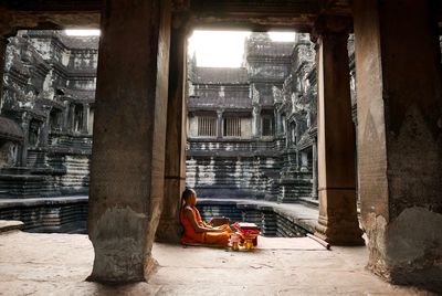 Monk sitting at temple