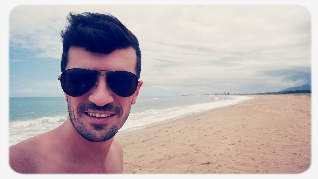 beach, sea, sand, water, shore, transfer print, leisure activity, lifestyles, person, portrait, looking at camera, young adult, sky, auto post production filter, vacations, sunglasses, horizon over water, headshot