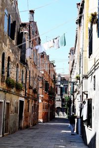Street amidst buildings in city against sky