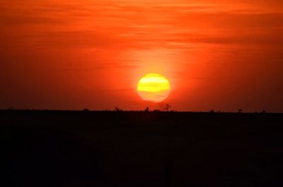 Scenic view of silhouette landscape against romantic sky at sunset