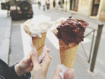 Close-up of hand holding ice cream cone