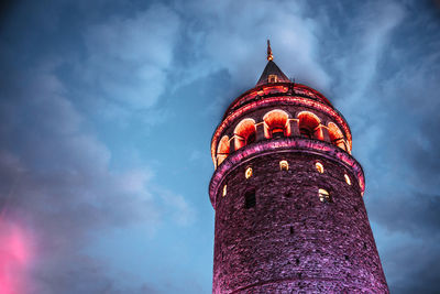 Low angle view of illuminated building against sky