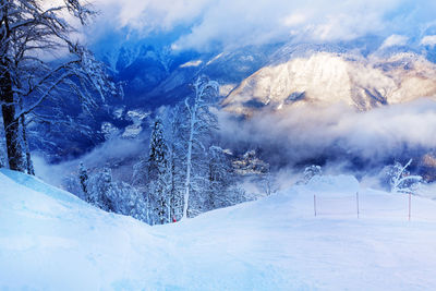 Scenic view of snow covered mountains against sky