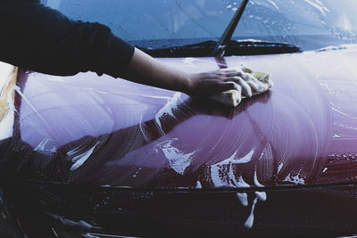 Cropped image of man washing car