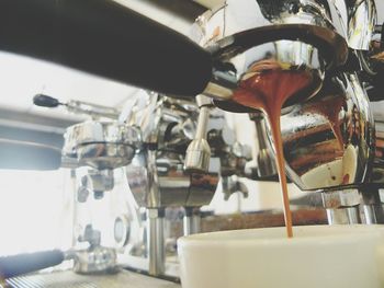 Close-up of pouring coffee in kitchen