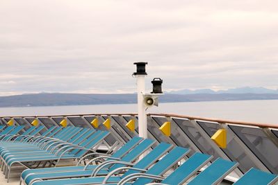 Railing by sea against sky