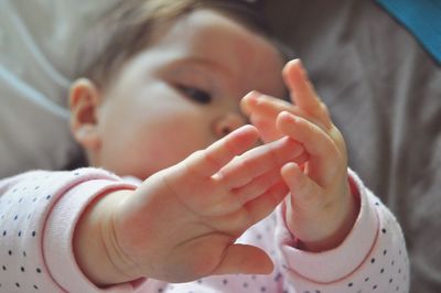 Close-up of baby holding hands