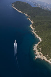 High angle view of airplane flying over sea