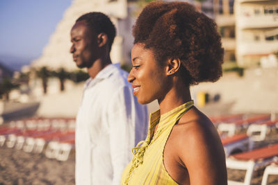 Couple standing at beach during sunset