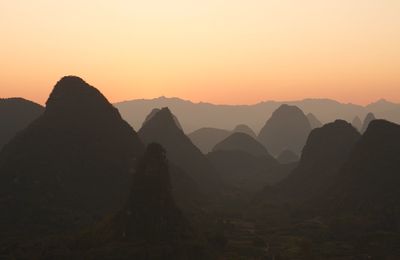 Scenic view of silhouette mountains against sky during sunset