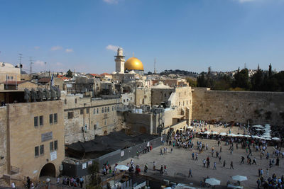 People praying at wailing wall of mosque