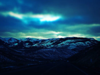 Scenic view of mountains against cloudy sky