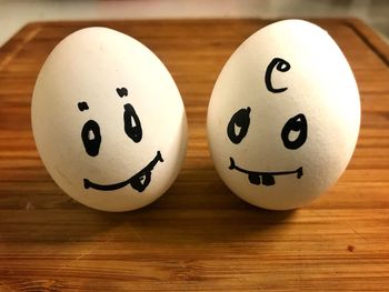 Close-up of smiley face on table