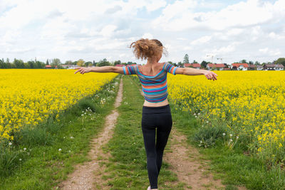 Rear view of person standing on field