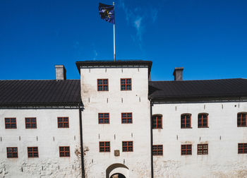 Low angle view of building against clear blue sky