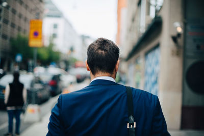 Rear view of man walking on street