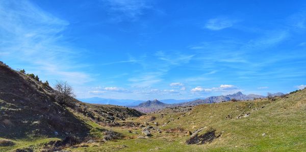 Scenic view of mountains against blue sky