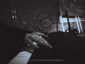 Cropped hand of person playing piano