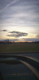 Scenic view of field against sky at sunset