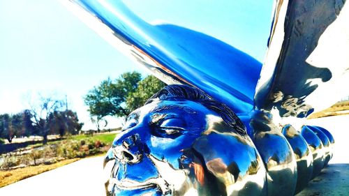 Close-up of statue against blue sky