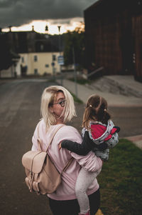 Girl standing on street in city