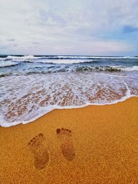 Scenic view of beach against sky