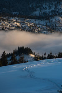 Scenic view of snow covered mountains against sky