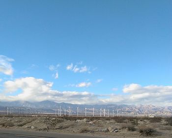 Scenic view of landscape against blue sky