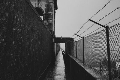 Empty narrow footpath on rainy day