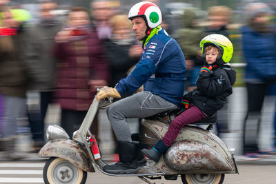 People riding motorcycle in city