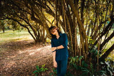 Young woman standing in forest