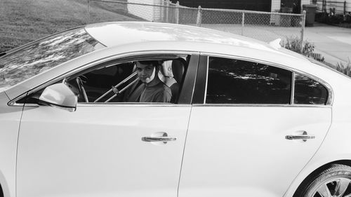 Reflection of man on car window