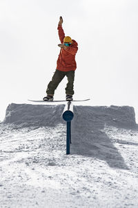 Full length of man standing on snow covered land