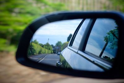 Reflection of car on side-view mirror