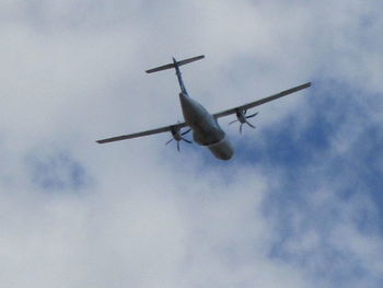 Low angle view of airplane flying in sky