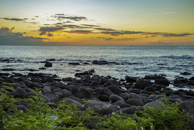 Sunset on the rocky beach of albion, mauritius.