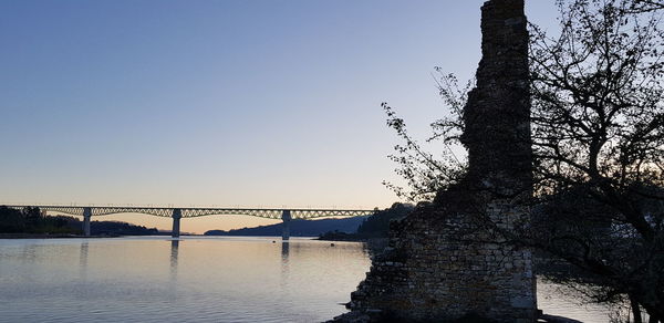 Bridge over river against clear sky