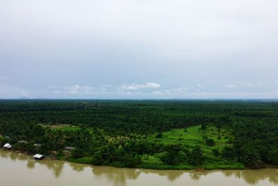 Scenic view of landscape against cloudy sky