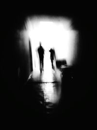 Silhouette of people in tunnel
